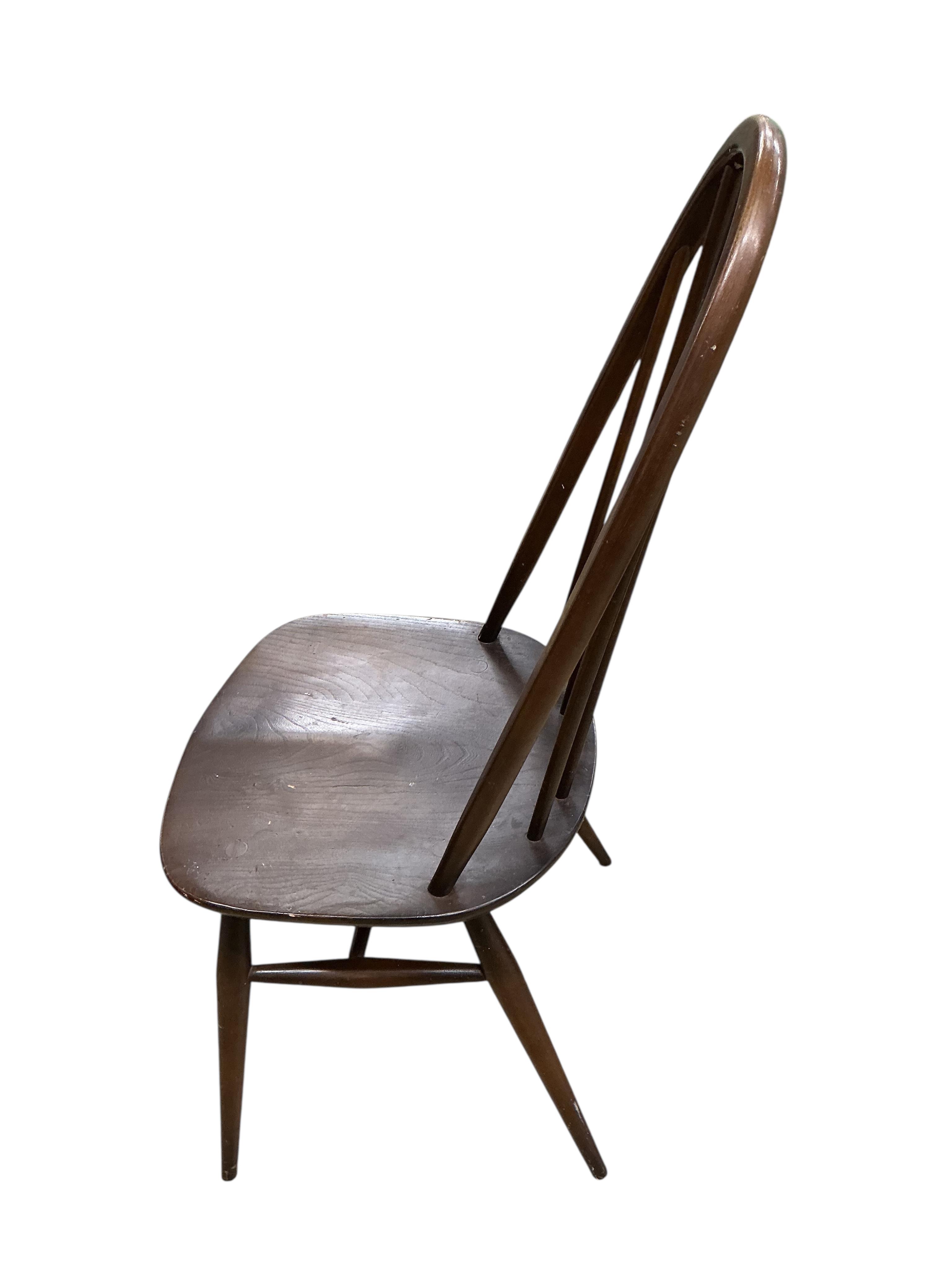 An Ercol dark elm rectangular dining table, width 150cm, depth 77cm, height 72cm and four Ercol chairs